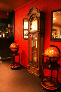 A granfather clock and two 'globe' bar trolleys complete that old-timey look