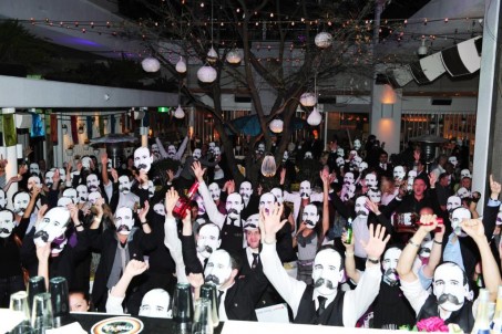 A crowd of Harry Johnson mask sporting cocktail fans at The  Magnificent 7 Final Shootout at Ivy