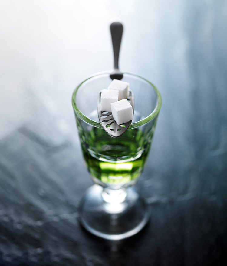 absinthe in pontarlier glass with spoon and sugar cubes